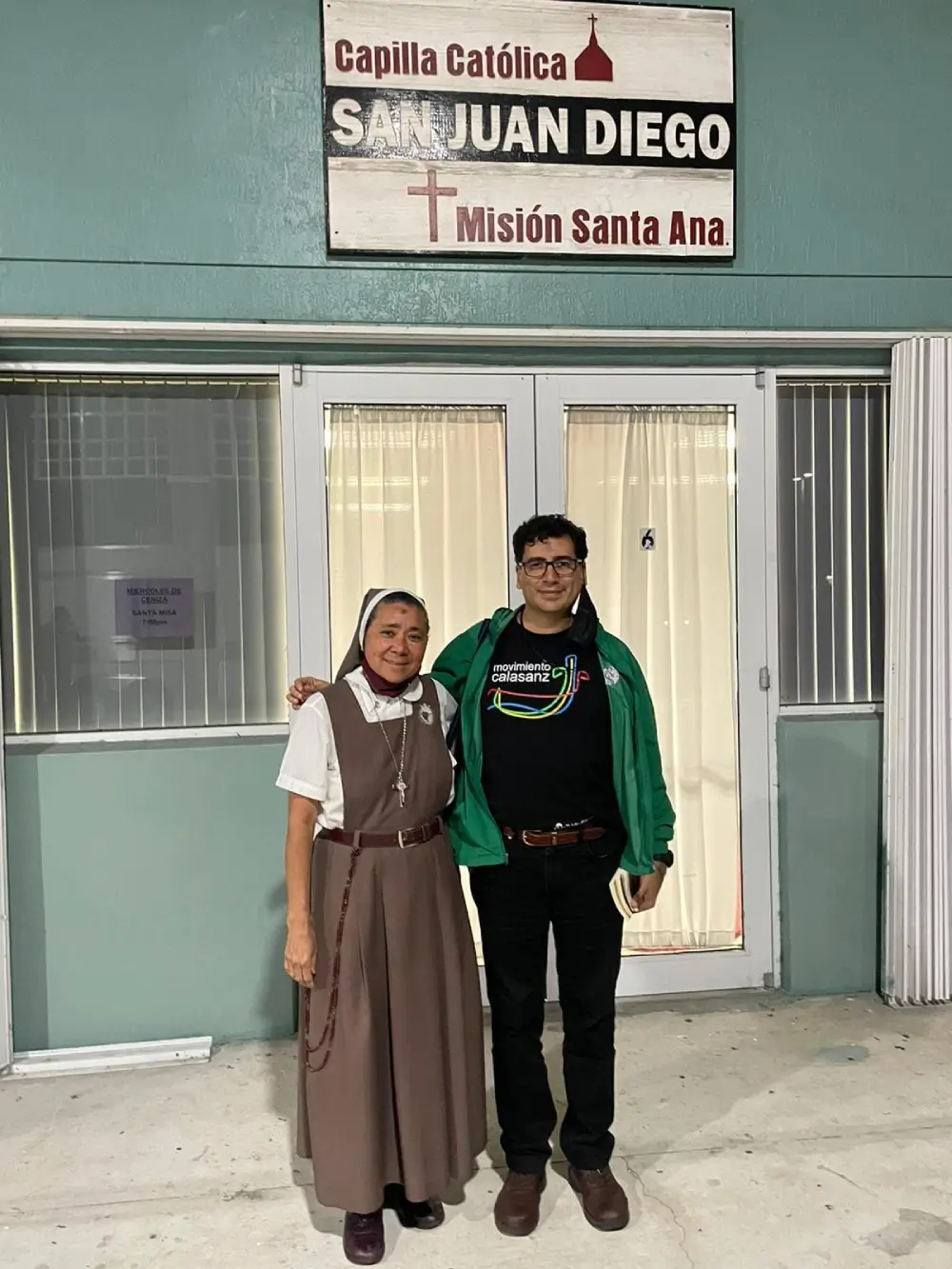 A man and a nun posing in front of Capilla Catolica San Juan Diego Mision Santa Ana